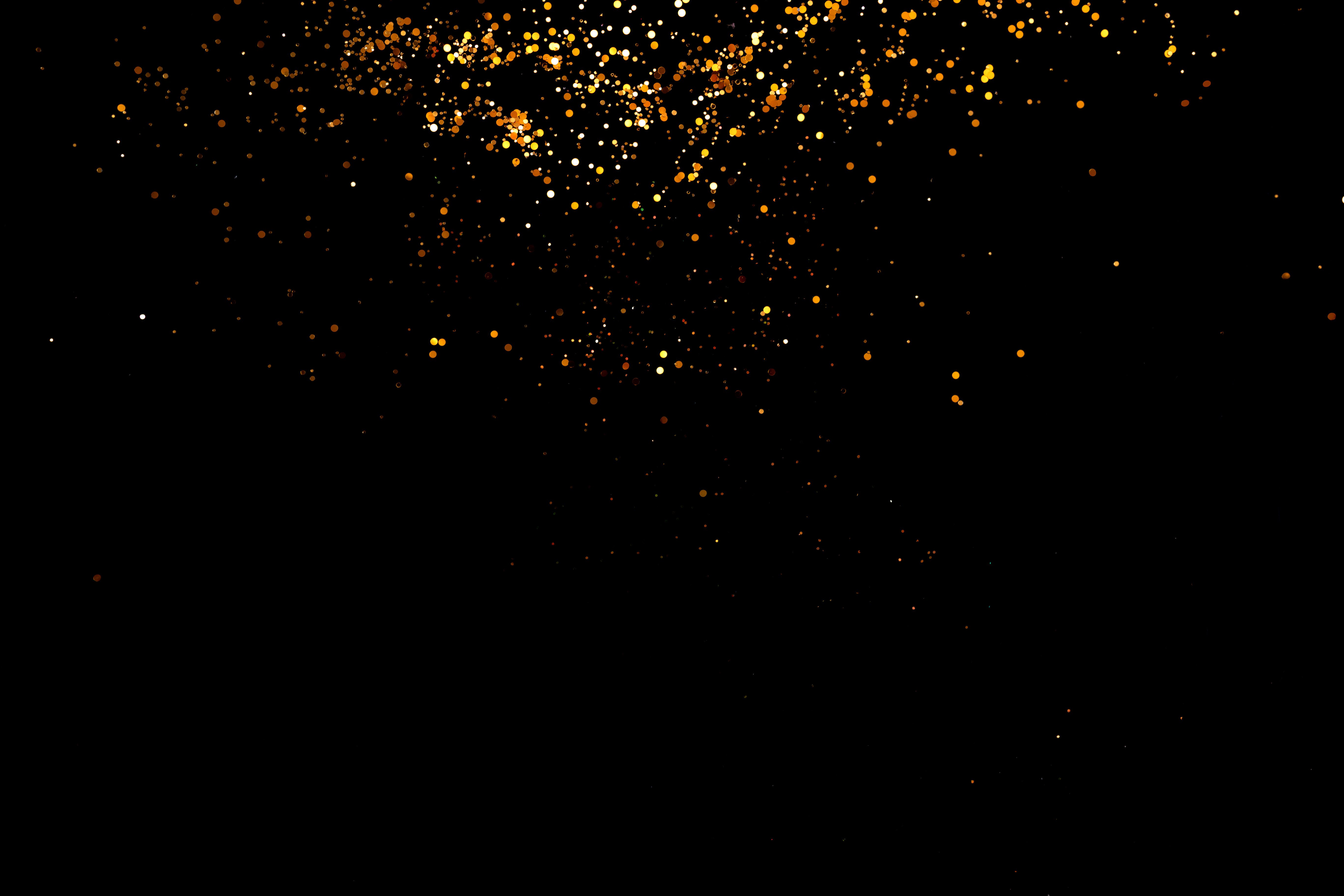 Golden sparkles on black background